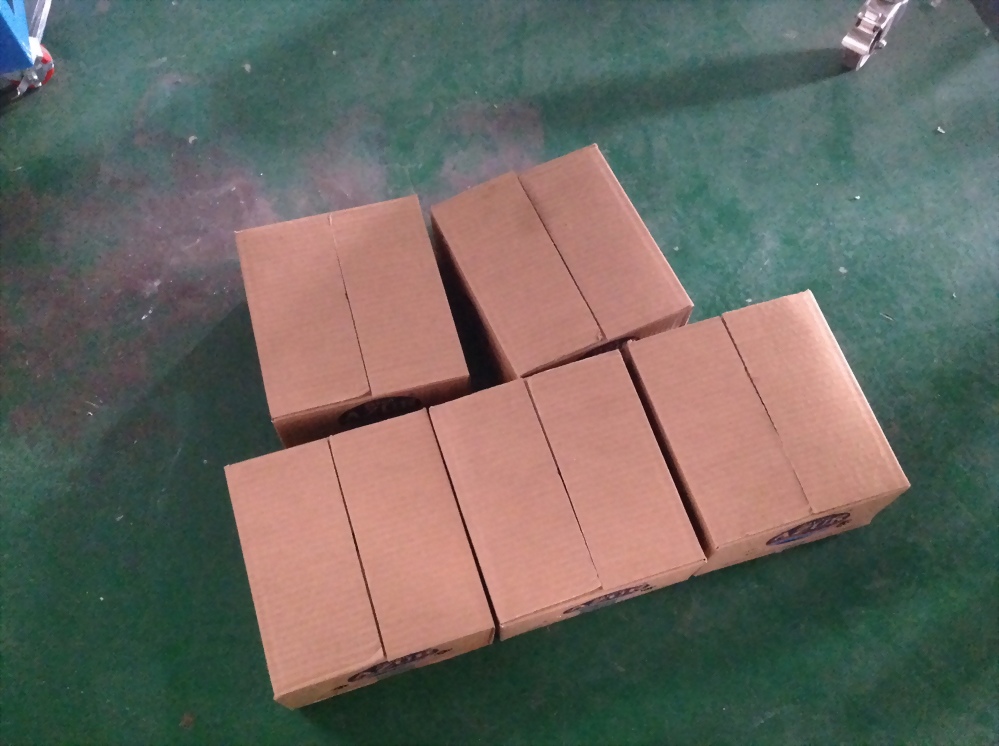 Five cardboard boxes industrial floor