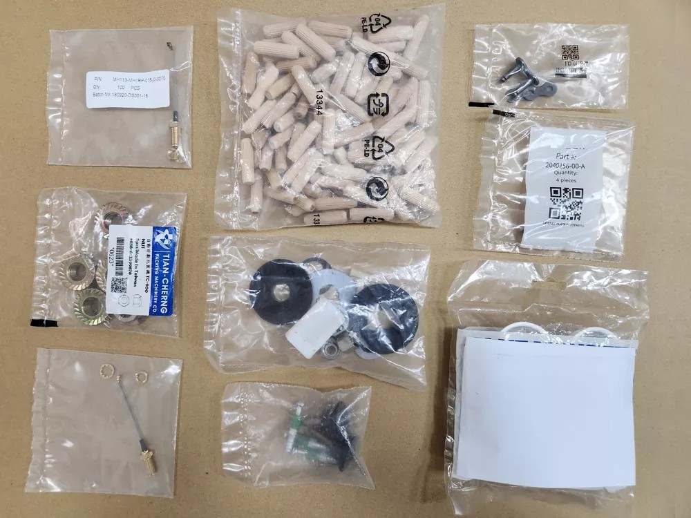 Assorted screws and hardware components packaged in clear bags.