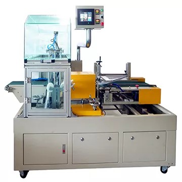 The sealing area is protected by a transparent safety guard for operator safety.
