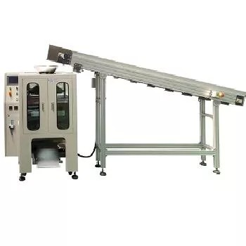 The TC-911 machine integrated with an output conveyor belt for finished products.