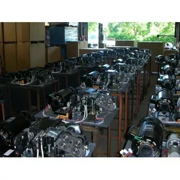 The TC-303AS strapping machine in an industrial workshop setting.