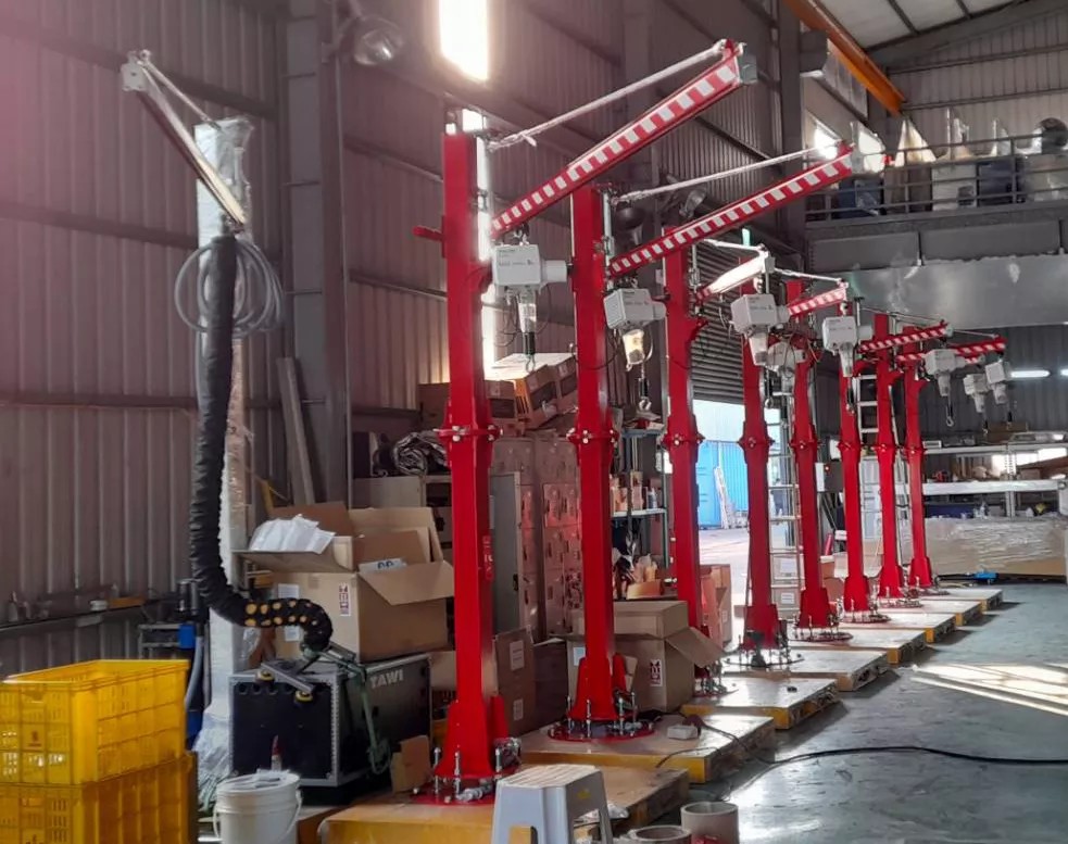 A row of Moon Lifter electric balancers ready for use in an industrial workshop