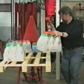 Man handling milk cartons pallet industrial setting