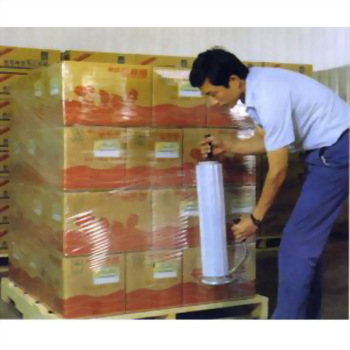 Man manual stretch film wrapping boxes pallet