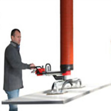Man operating industrial vacuum lifter flat panel