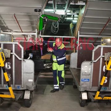 A vacuum lifter being used in a logistics warehouse setting.