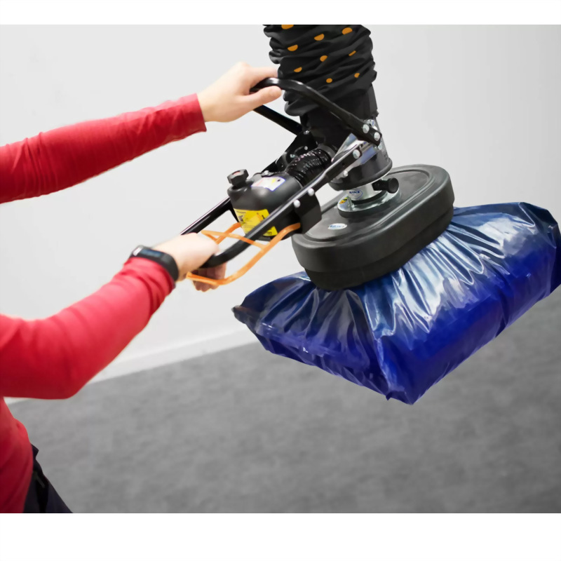 Person operating vacuum lifter blue package handling