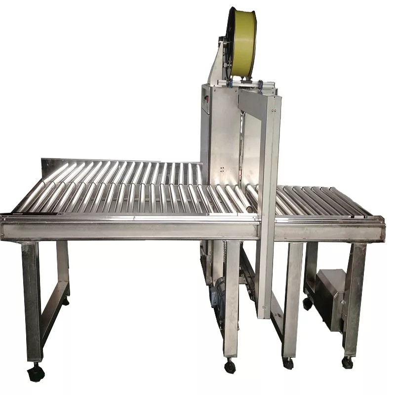 Close-up of the strapping material feed system on the TC-8565AY2S side strapping machine.