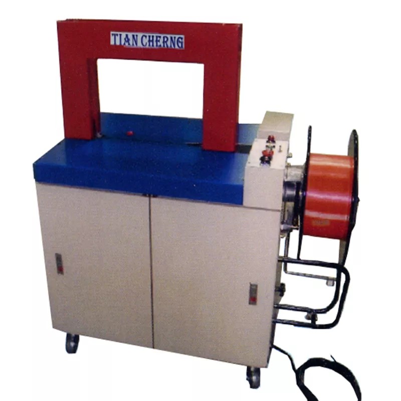 TC-4530A mini strapping machine with a red PP strap spool installed