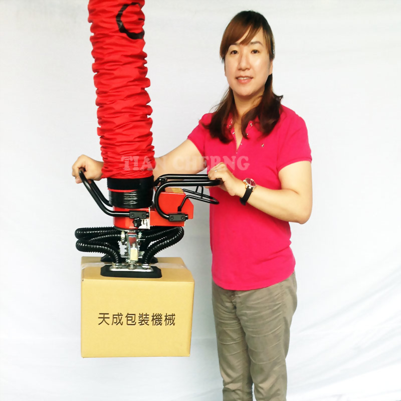 Woman demonstrates tian cheng vacuum lifter packaging machine