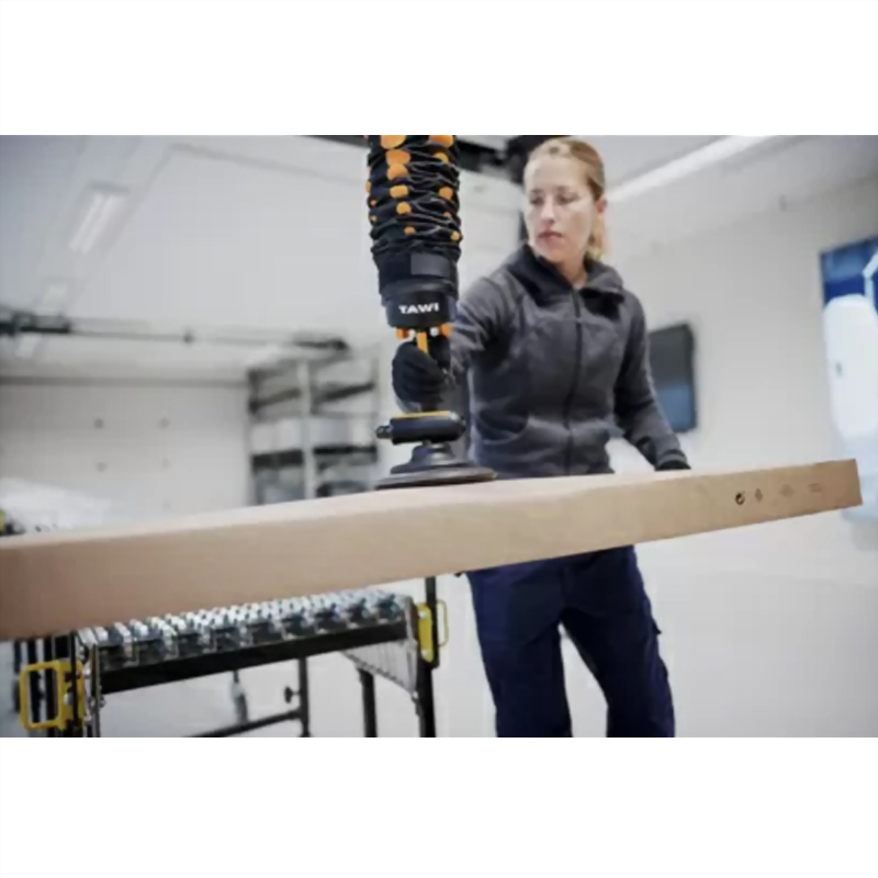Woman tawi vacuum lifter cardboard box warehouse
