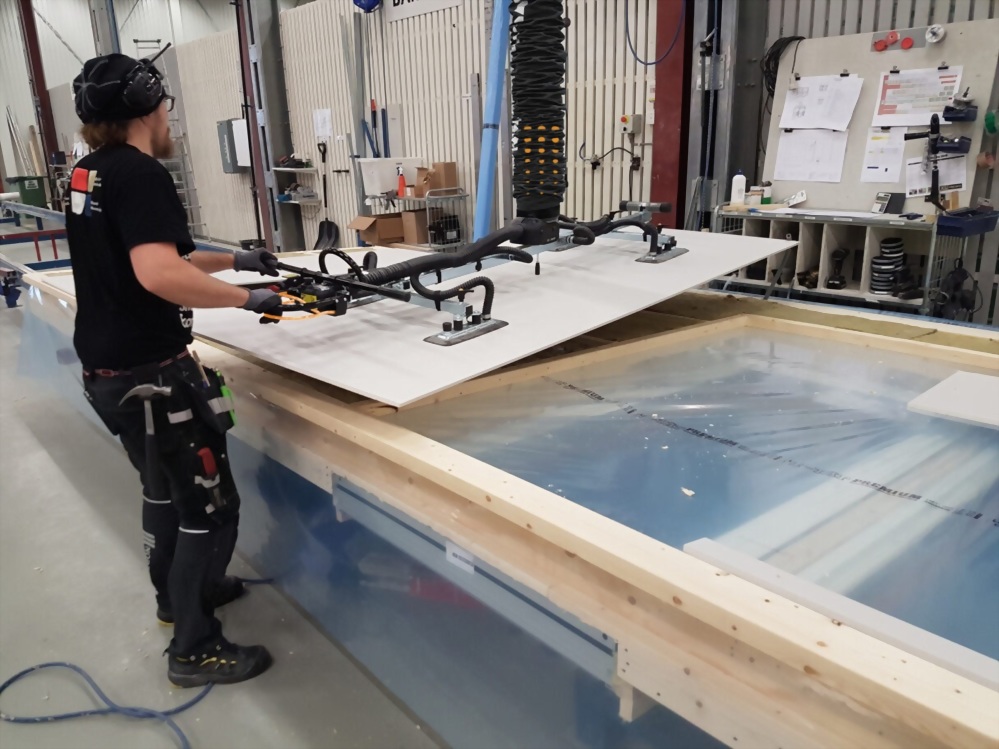 Worker vacuum lifter panel handling industrial manufacturing